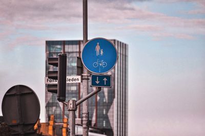 Low angle view of road sign against sky