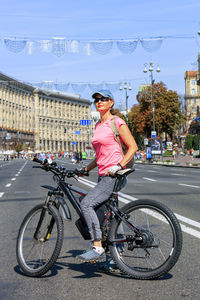 Man riding bicycle on street in city