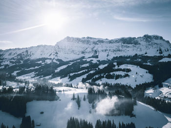Scenic view of snowcapped mountains against sky during winter