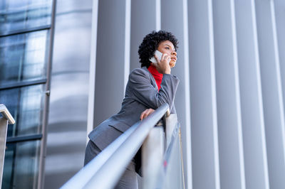 A young african-american businesswoman wearing a red turtleneck and a suit in a business building