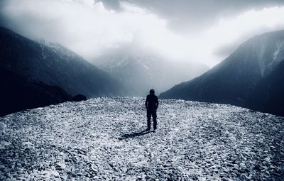 Full length of man on snowcapped mountains against sky