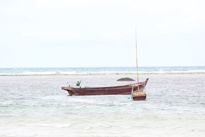 Boat in sea against sky