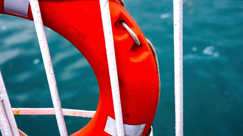 Close-up of rope tied to bollard against sea