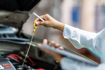 Cropped hand of man repairing car