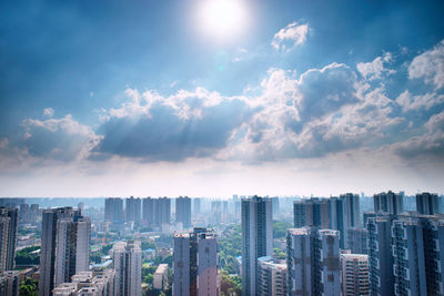 Aerial view of buildings in city against sky