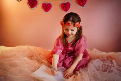 Girl writes a valentine