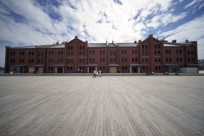 Buildings in city against cloudy sky