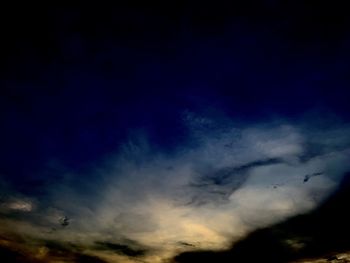 Low angle view of dramatic sky at night