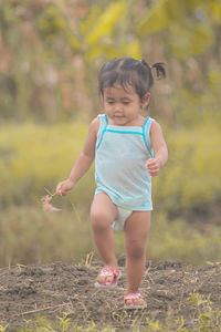 Full length of cute baby girl on field