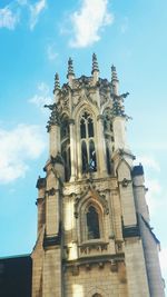 Low angle view of bell tower against cloudy sky