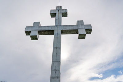 Low angle view of cross sign against sky