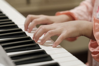 Midsection of person playing piano