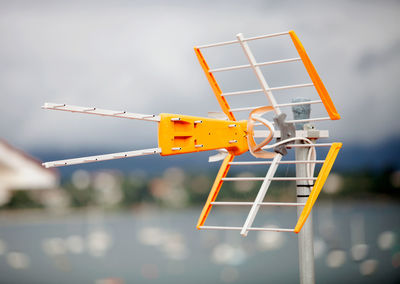 Low angle view of crane against sky