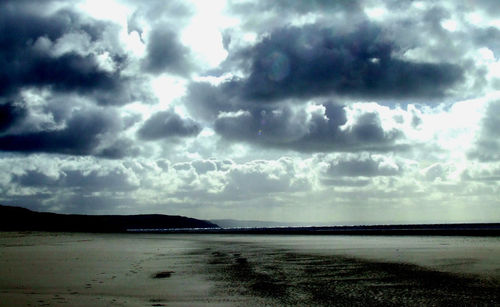 Scenic view of sea against storm clouds