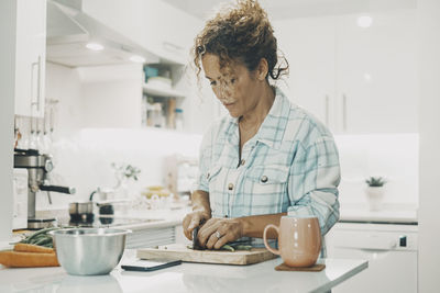 Side view of young woman working at home