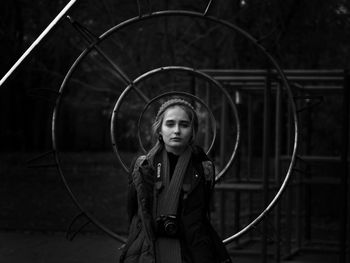 Portrait of woman amidst circular metals