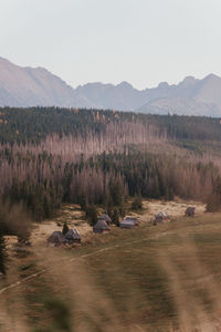 Scenic view of land and mountains against sky