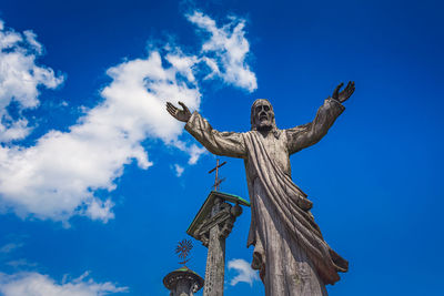 Low angle view of statue against blue sky