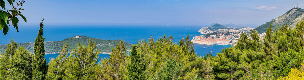 Panoramic view of sea and mountains against sky