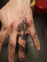 Close-up of human hand with tattoo