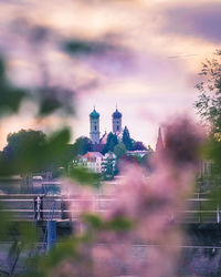 Panoramic view of buildings and trees against sky