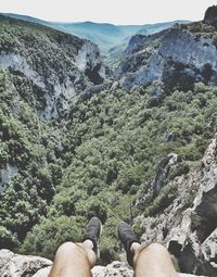 Low section of person relaxing on rock