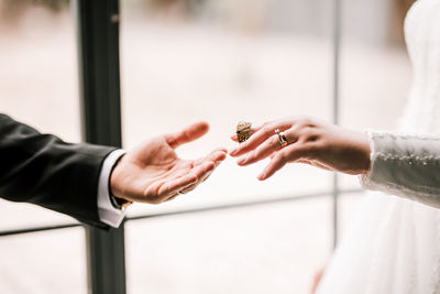 Midsection of couple holding hands