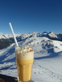 Close-up of drink against clear sky during winter