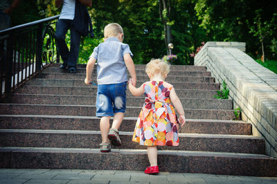 Rear view of people walking on staircase