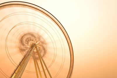 Low angle view of ferris wheel against clear sky