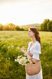 Young woman standing on field