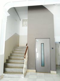 Rear view of woman walking on staircase of building