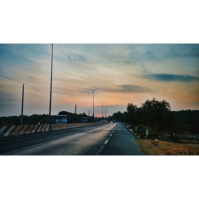 transportation, the way forward, road, diminishing perspective, sky, road marking, sunset, vanishing point, car, mode of transport, cloud - sky, land vehicle, tree, windshield, cloud, transfer print, auto post production filter, country road, travel, no people