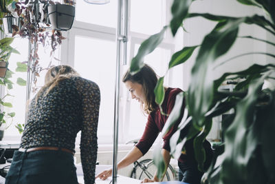 Female entrepreneurs discussing at table in creative office