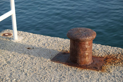 High angle view of bollard against sea at harbor