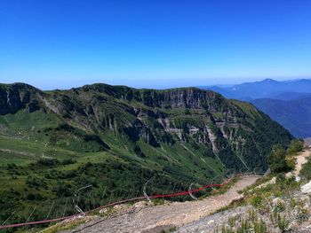 Scenic view of mountains against clear blue sky