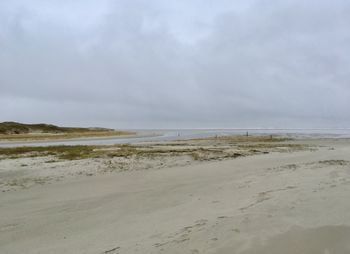 Scenic view of empty beach against sky