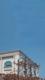 Low angle view of building against clear blue sky