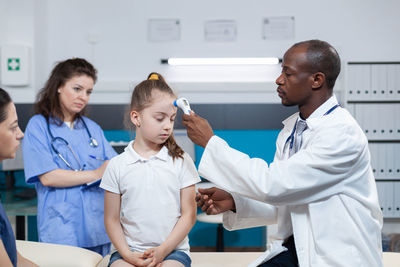 Female doctor examining patient in hospital