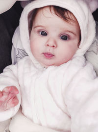 Portrait of cute baby lying on bed