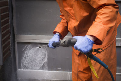 Person cleaning wall