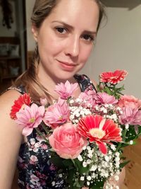 Portrait of beautiful woman with pink flowers