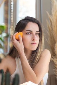 Portrait of smiling young woman using mobile phone in gym