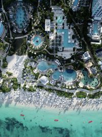 High angle view of swimming pool by buildings in city