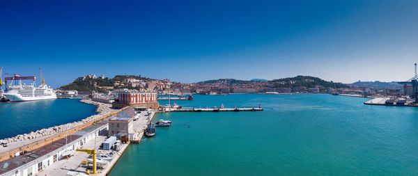 High angle view of bay and buildings against clear sky