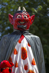 Close-up of statue in costume against trees