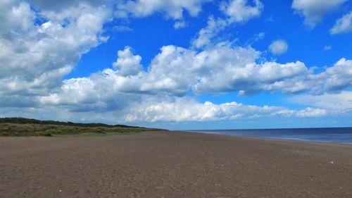 Scenic view of sea against cloudy sky