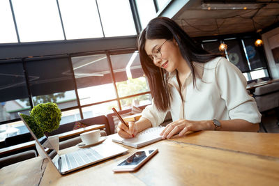 Woman using laptop on table