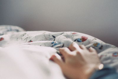 Close-up of woman resting on bed