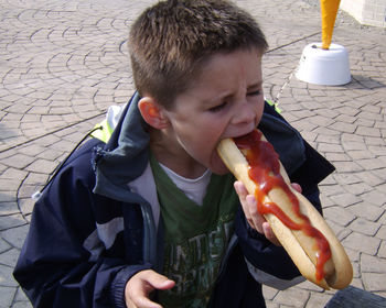 Boy eating hot dog